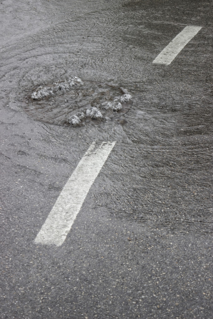 Water is bubbling up through manhole cover and sewer 4